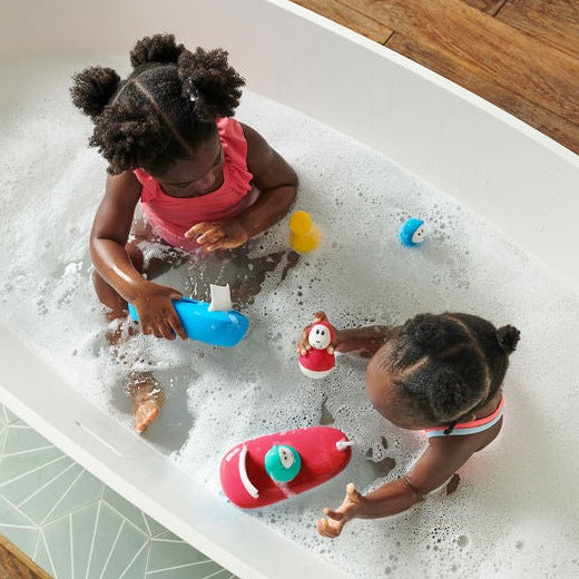 Red and white silicone boat set with bobbing monkey.