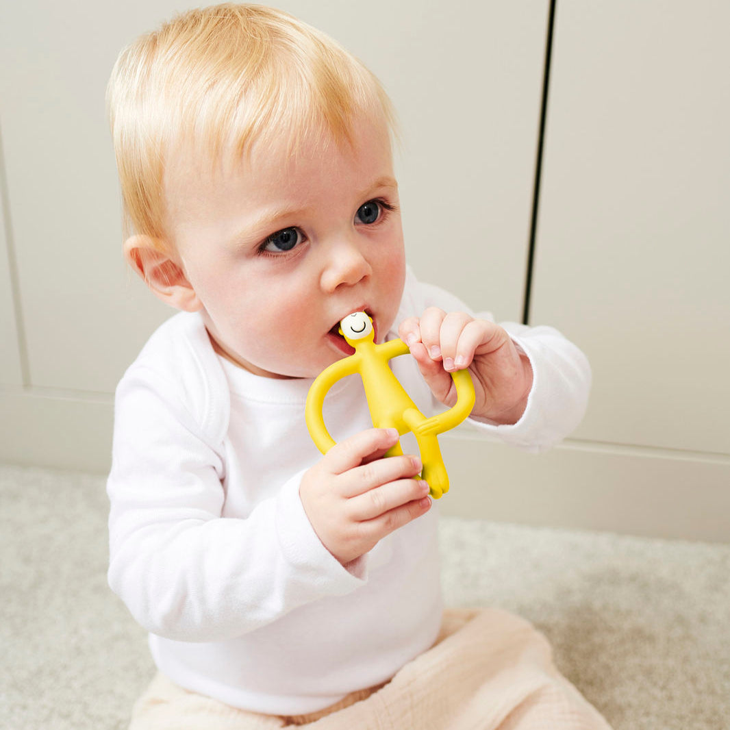 Yellow silicone teething toy monkey.