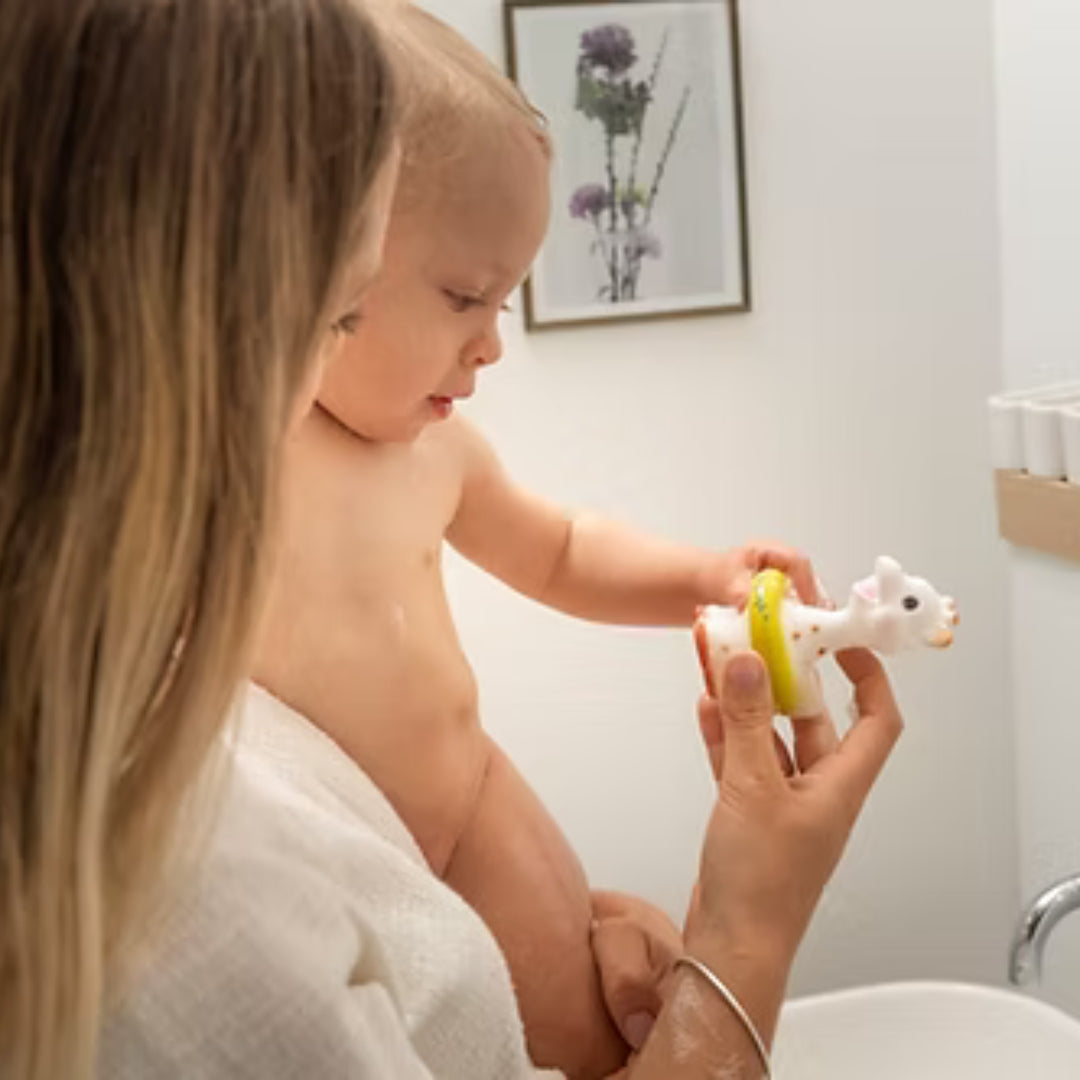 Child playing with a toy in a bathroom setting