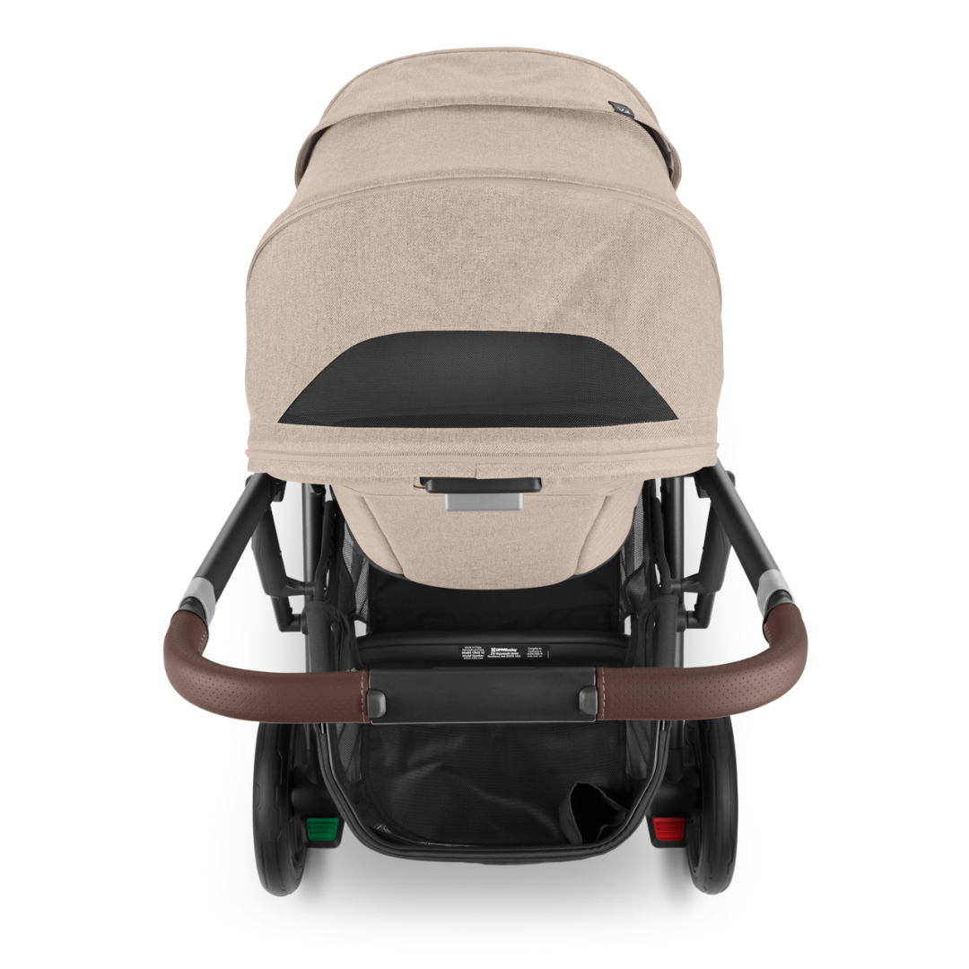 UPPAbaby Cruz V2 stroller. Oat fabric, Carbon Frame and Chestnut Leather accents on handle bar and bumper bar. Back View.