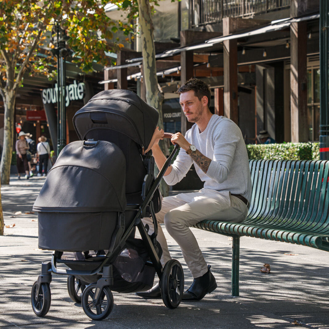 UPPAbaby Vista Nori Stroller. Black fabric, black carbon frame and Chestnut leather handle and bumper bar. Set up in double mode with bassinet and toddler seat.