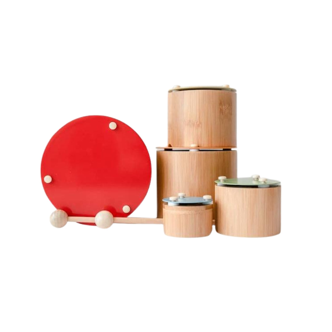 Set of wooden instruments with a red lid on a white background