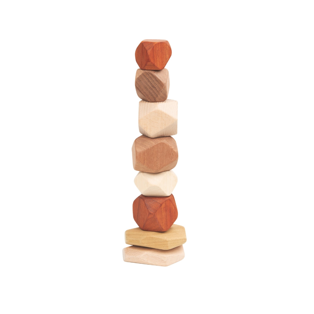 Stack of wooden blocks with different shapes and colors on a white background