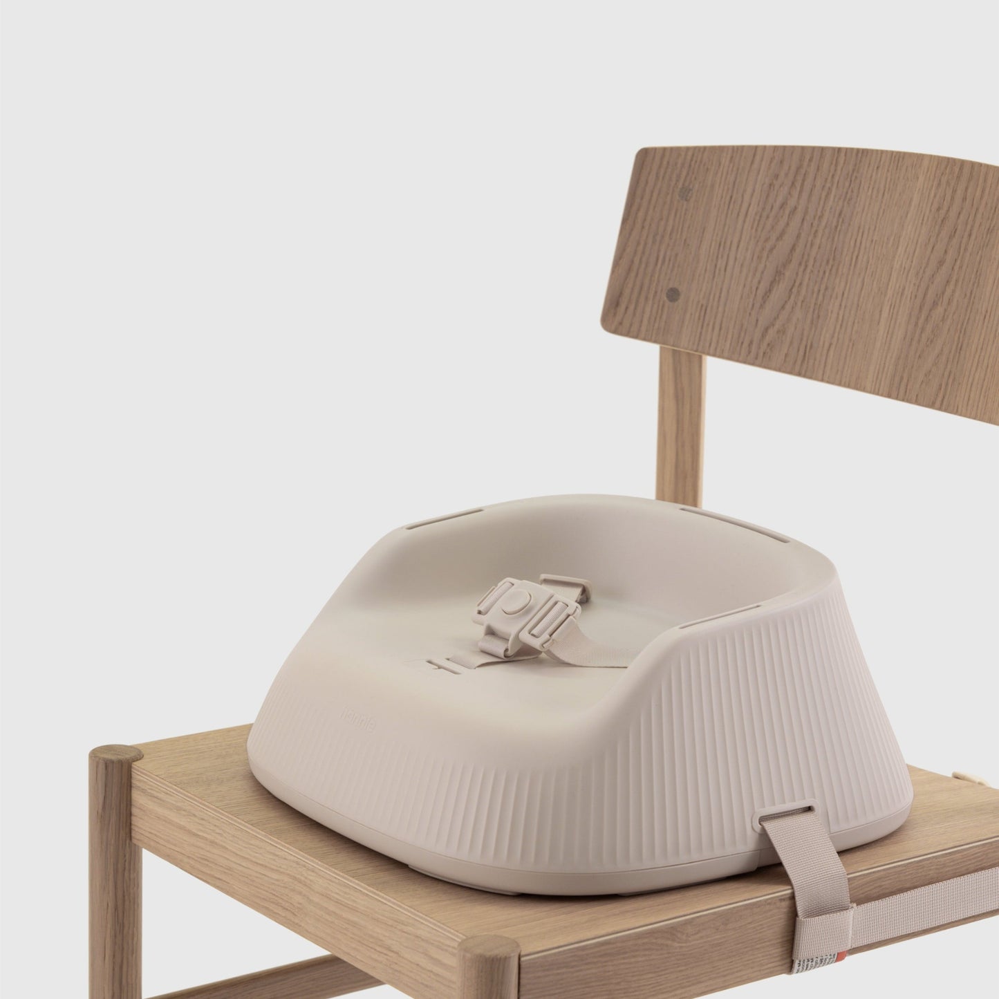 Baby high chair booster seat attached to a chair on a white background