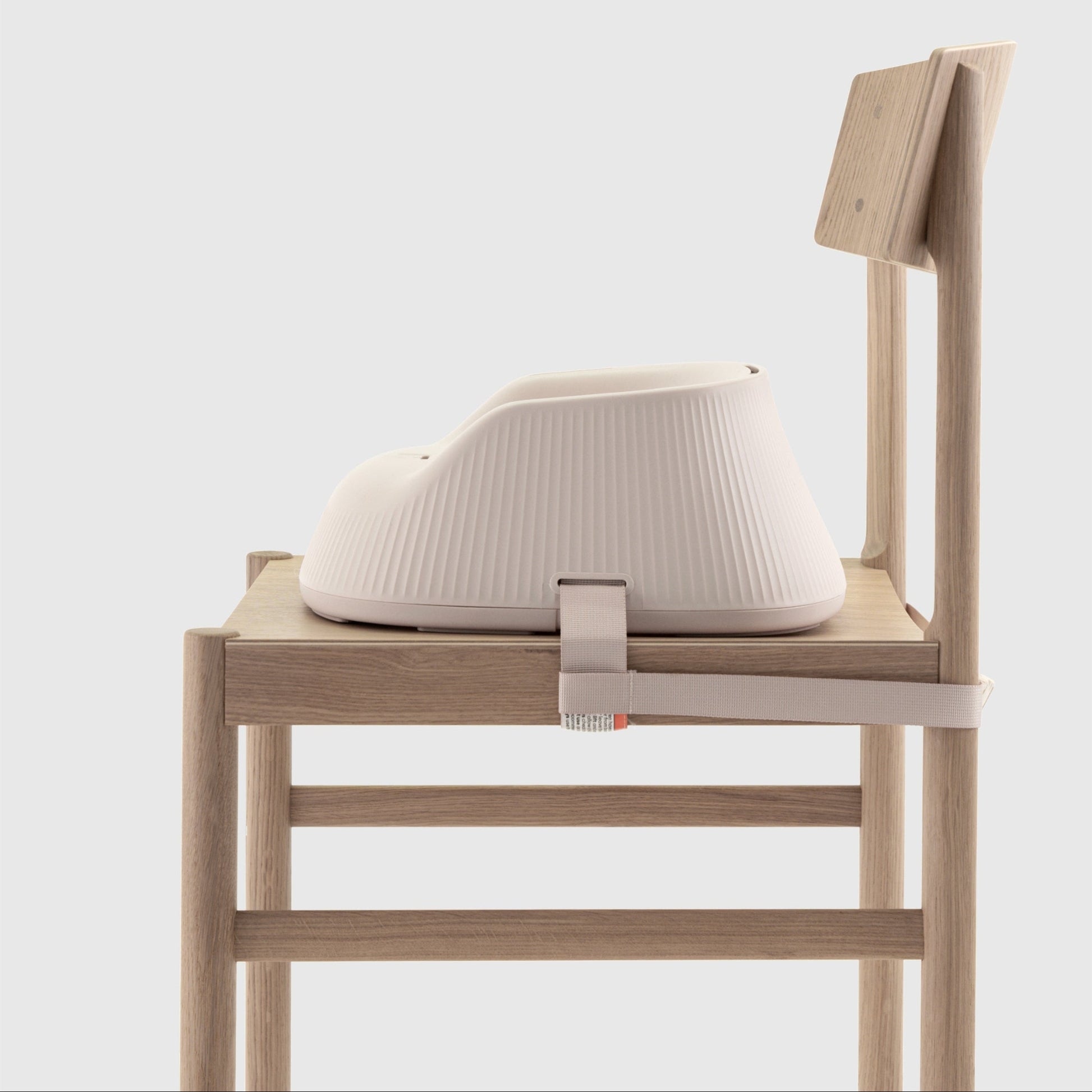 Baby high chair booster seat  attached to a chair on a white background