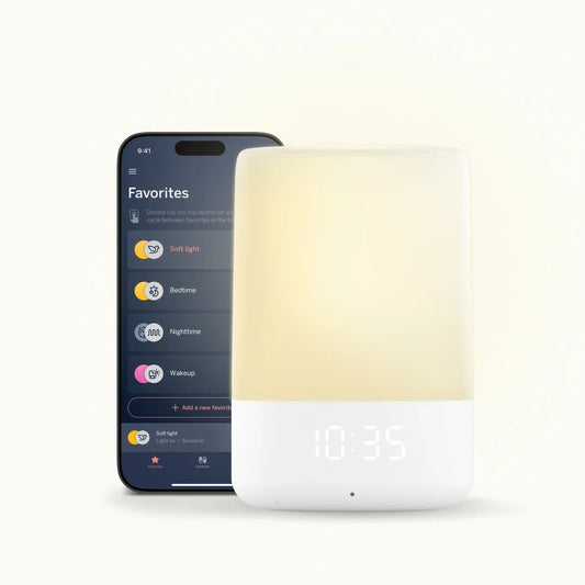 Smartphone displaying a  app next to a white smart light on a white background