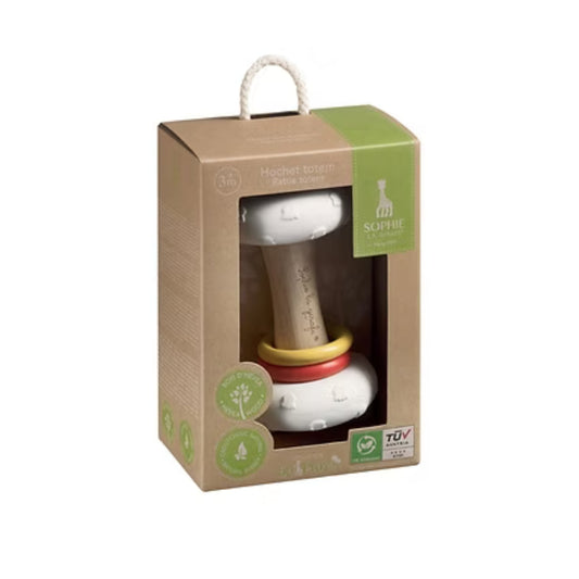 Baby rattle in a cardboard box with green accents on a white background