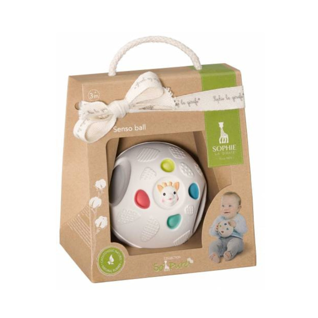 Baby ball toy in a decorative box with a bow on a white background