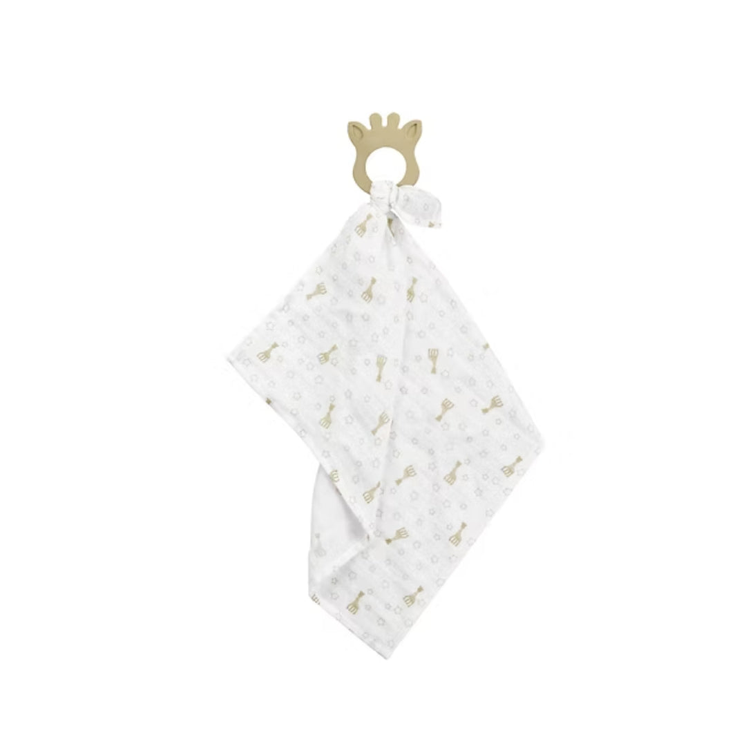 White baby blanket with sophie la girafe pattern and giraffe teether attached on a white background