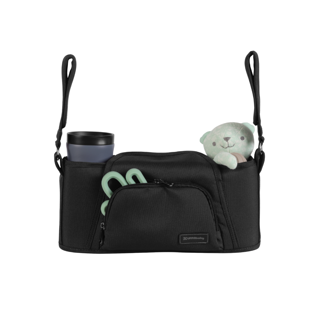 Black Parent organiser for UPPAbaby stroller with a cup, teether and teddy in it on a white background