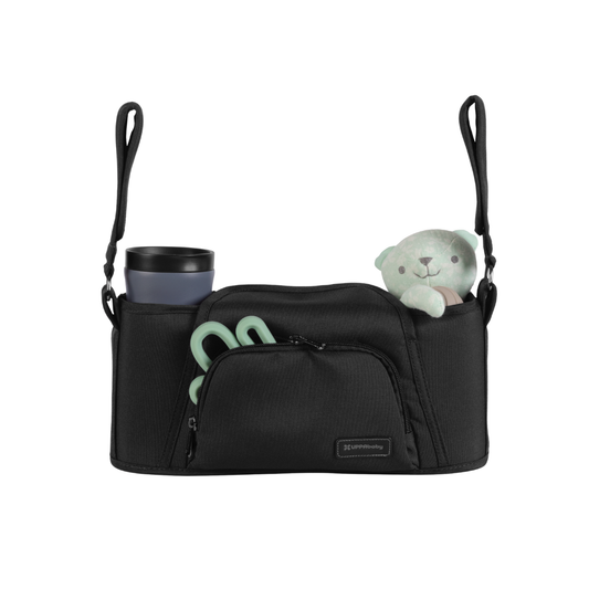 Black Parent organiser for UPPAbaby stroller with a cup, teether and teddy in it on a white background
