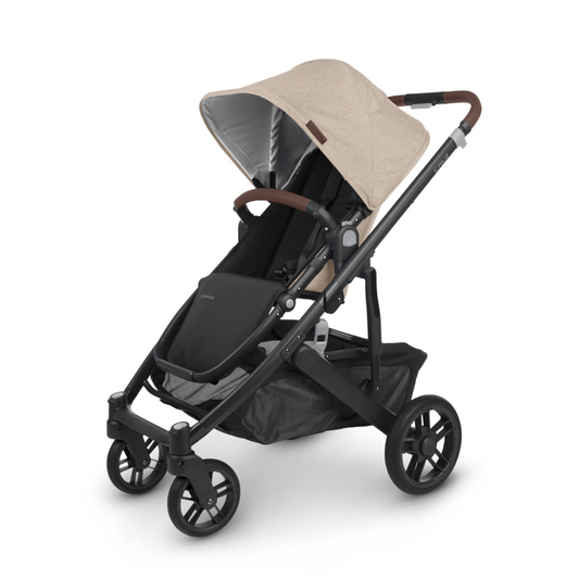 UPPAbaby Cruz V2 stroller. Oat fabric, Carbon Frame and Chestnut Leather accents on handle bar and bumper bar. Main image of stroller. 