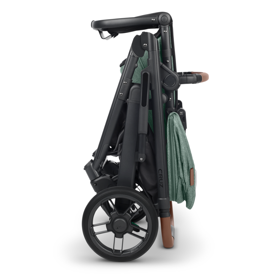 UPPAbaby Cruz V2 Stroller in Gwen Green Melange Fabric, Carbon Frame and Saddle Leather detail on handle and bumper bar. Folded and free standing. 