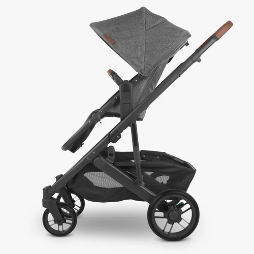 Black and gray stroller on a white background with upper adapters attached to toddler seat. 
