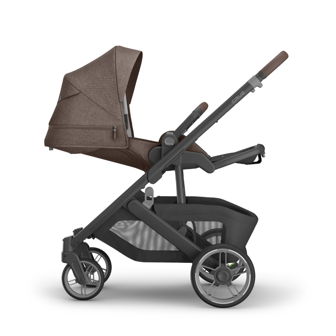 Stroller with Carbon black frame, Mocha melange fabric and chestnut leather accents with seat reclined. 