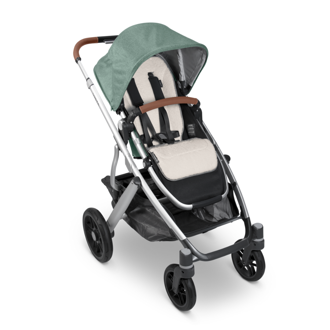 Liner on stroller showing white fluffy side. 