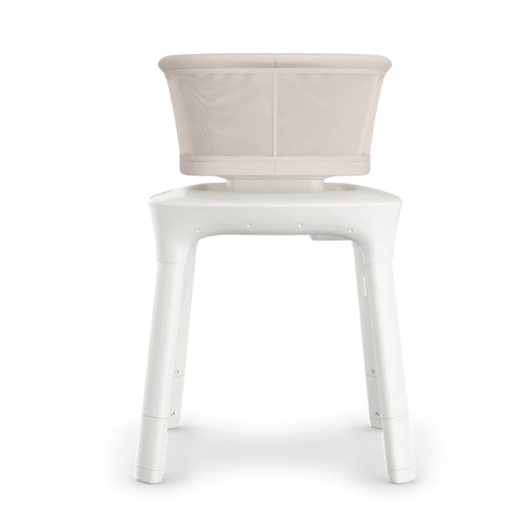 UPPAbaby sand coloured mesh  baby bassinet with white legs showing side profile on a white background.