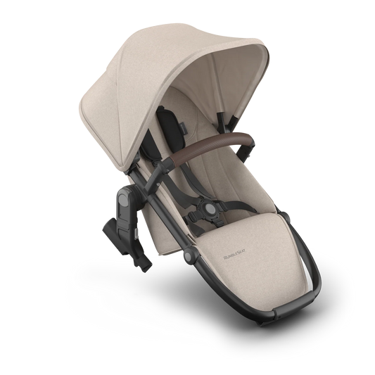 Beige baby stroller seat with black accents on a white background