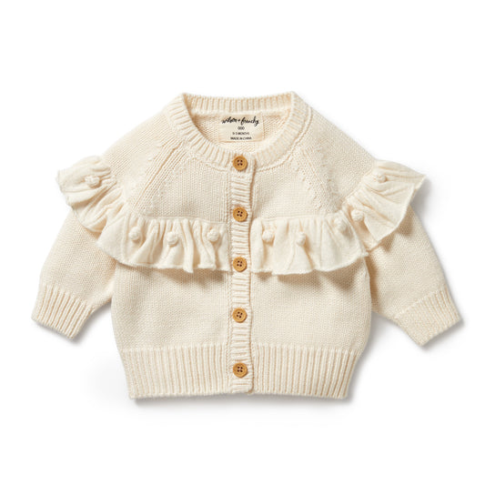 Ecru Baby cardigan with front fruffle and small pom pom detail. Wooden buttons. 