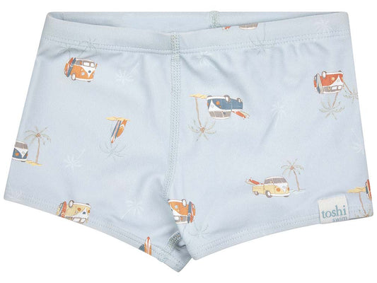 Swim shorts with pale blue base and colourful combi vans and surf board print. 
